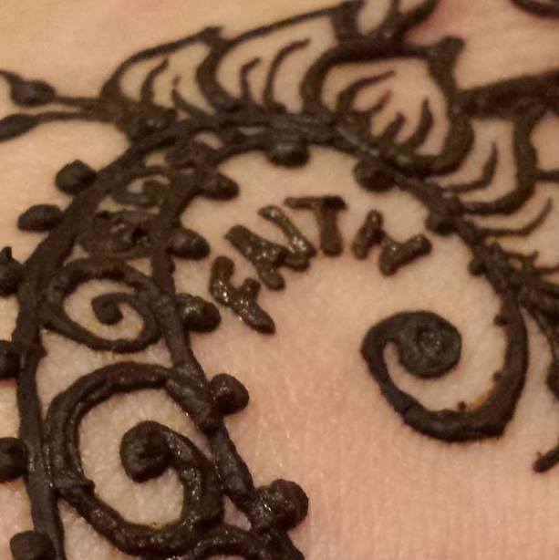 Henna swirl with the word faith.